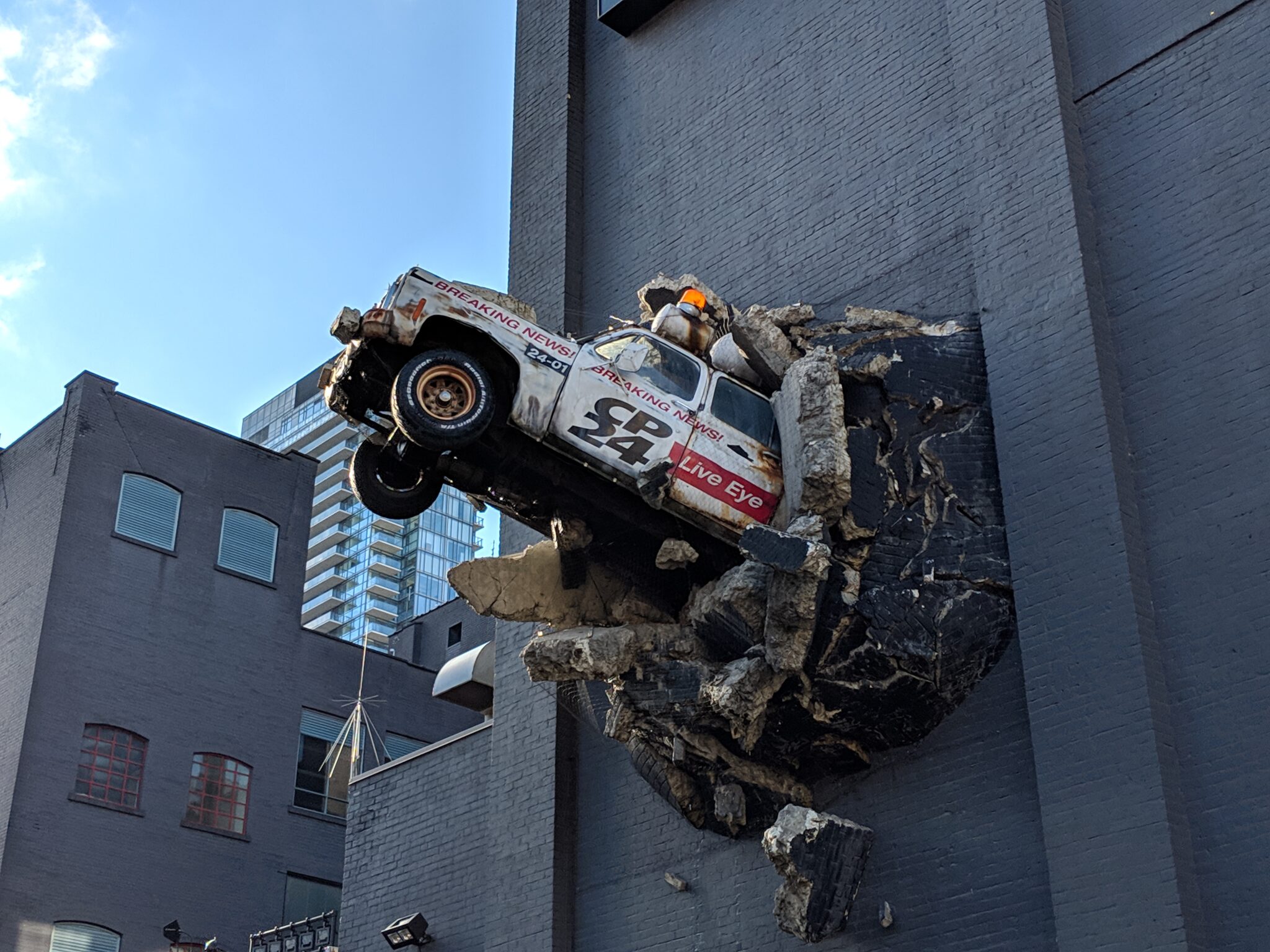 A breaking-news truck bursting out of MuchMusic HQ's east wall on Queen Street West.

????:  Sikander Iqbal