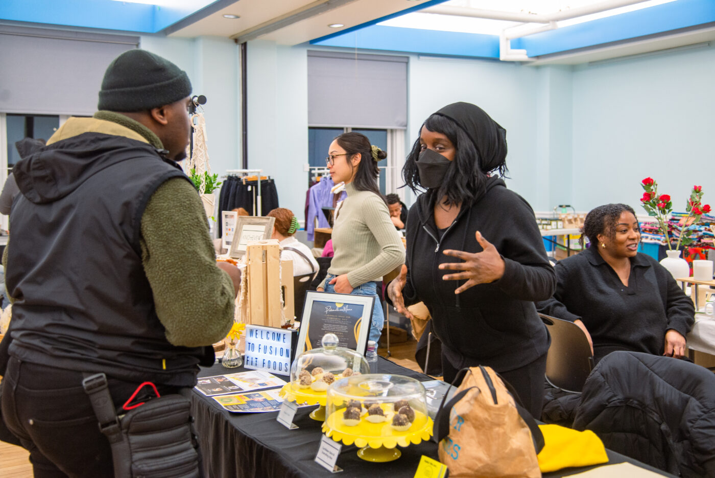 A local vendor interacts with a customer at the Winter Marketplace. (Aloysius Wong/The Green Line)