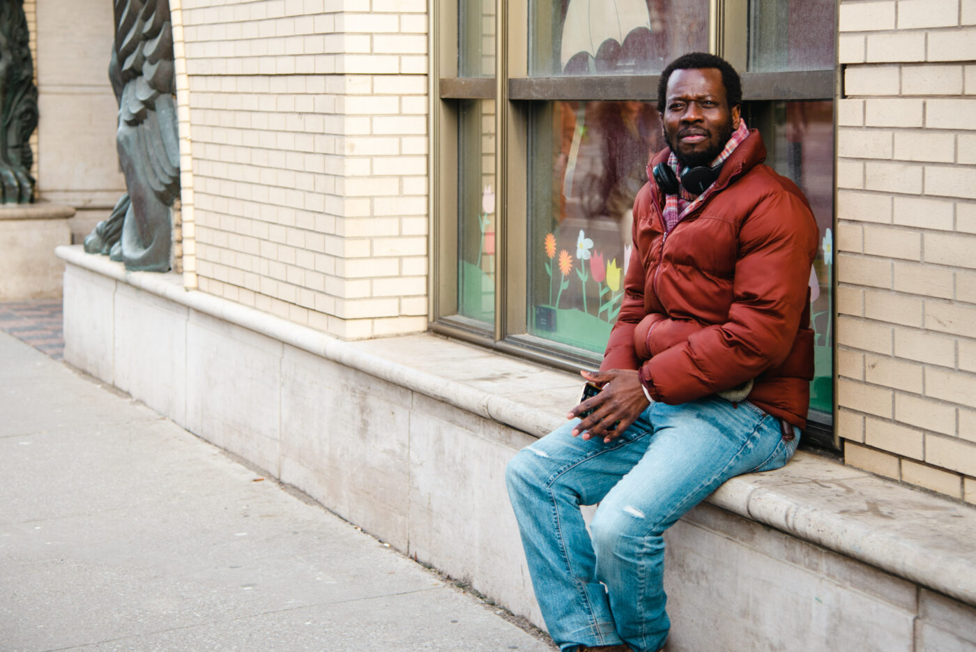 Olivier M. sits outside the Lillian H. Smith library at 239 College St., where he frequently spent time when he was homeless.