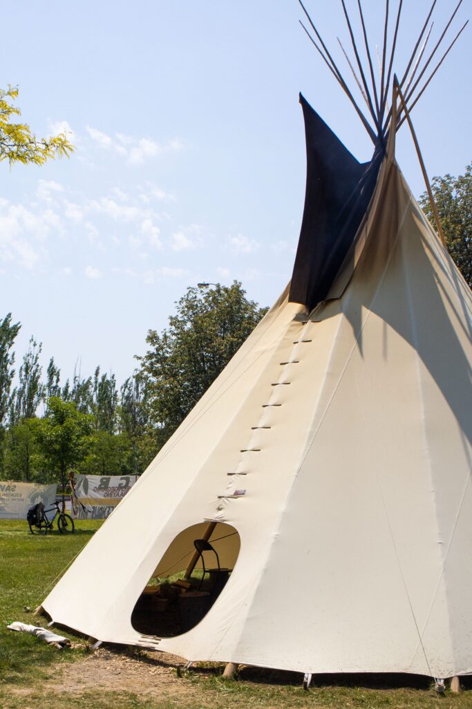 A tipi in a park.