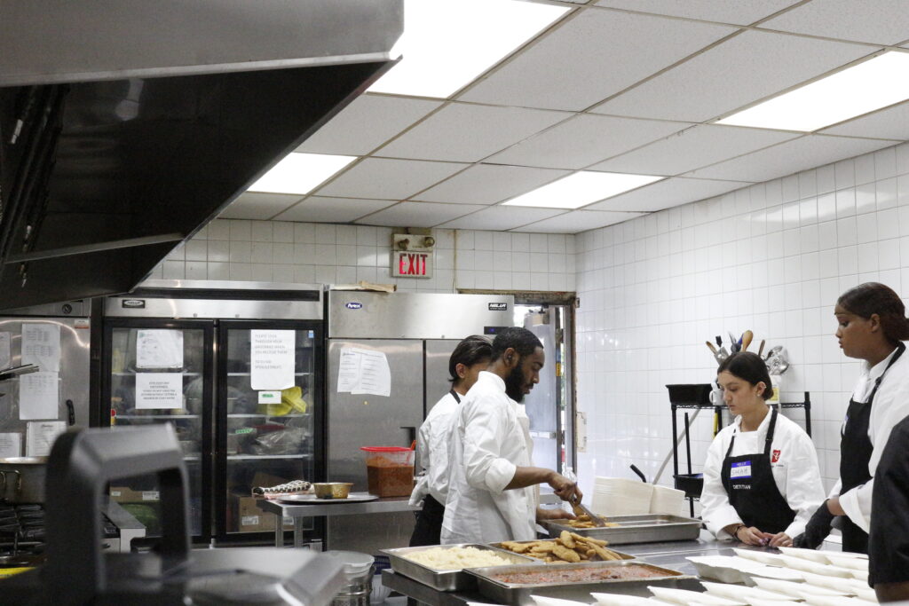 Youth prepare meals inside Frontlines kitchen.