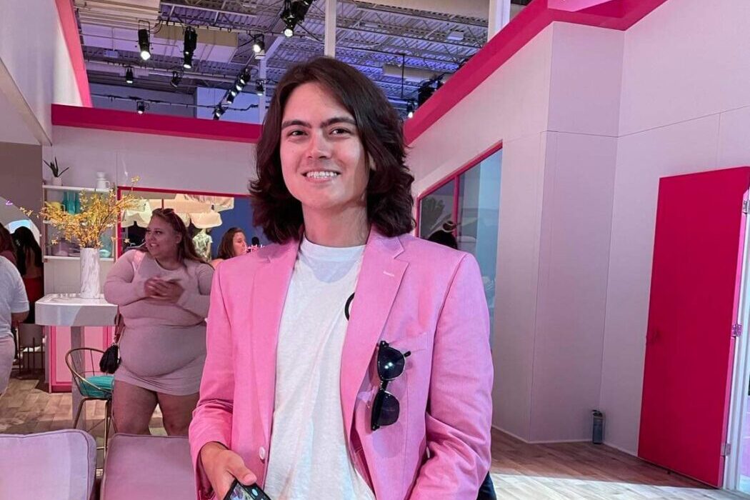 A young man in a pink blazer