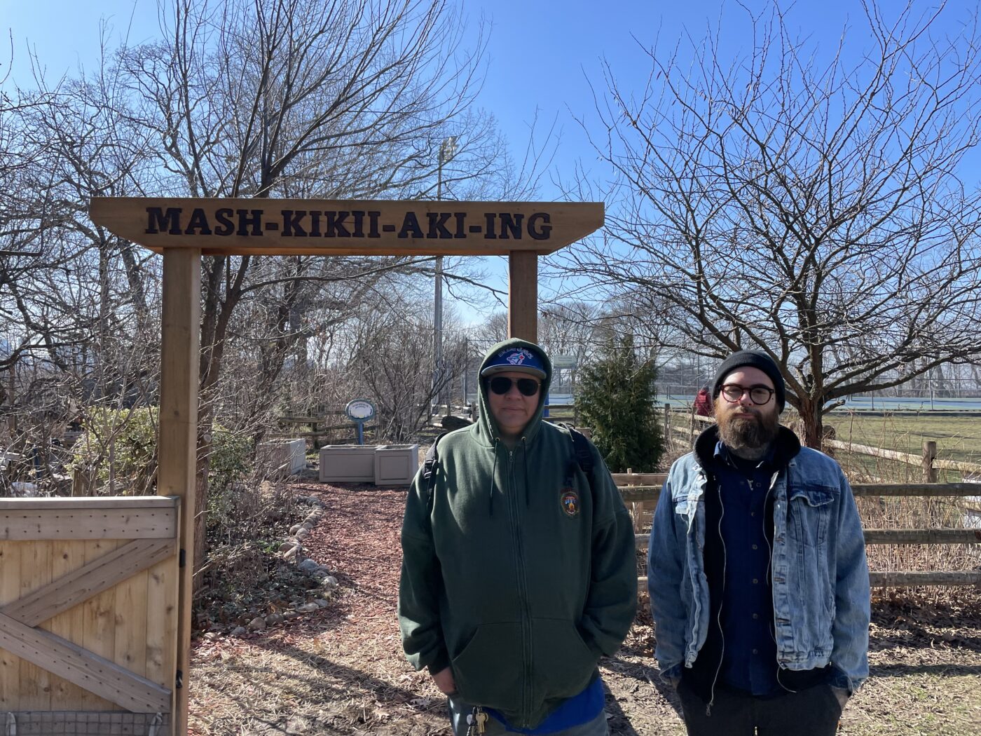 Big Thunder (pictured left) and Karl Cousineau (pictured right) stand in front of the Mashkikiiaki'ng garden in Hillcrest Park
