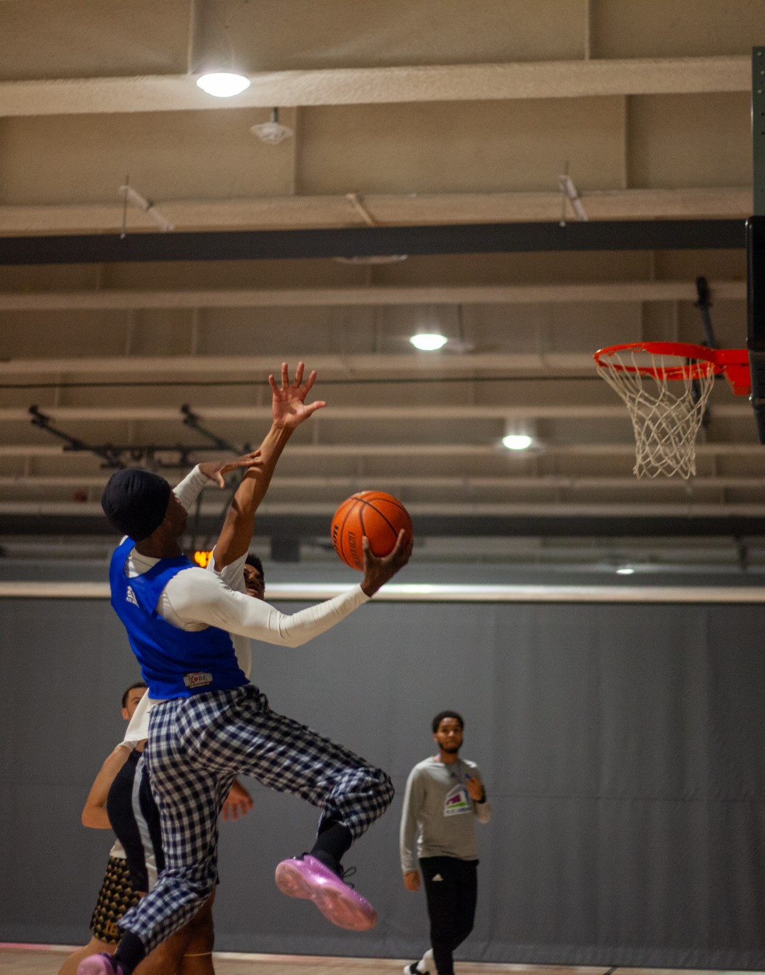 Player jumps up for a lay up shot at The Green Line's Local Basketball Pipeline action journey.