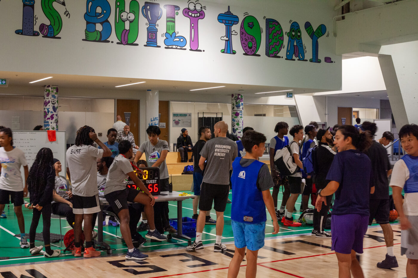 Players mingle at The Green Line's local basketball pipeline action journey.