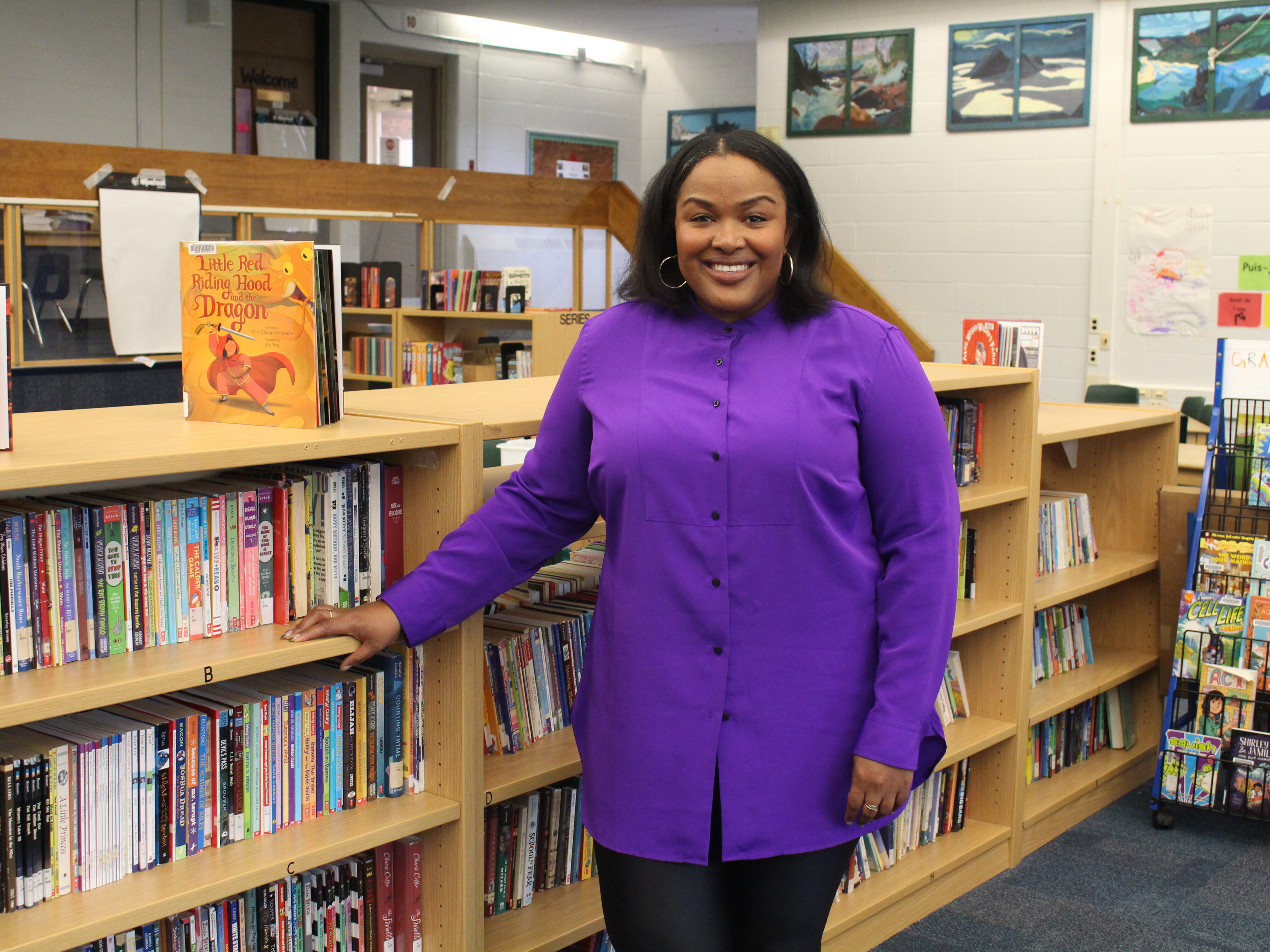 Camesha Cox, founder of The Reading Partnership stands by library.