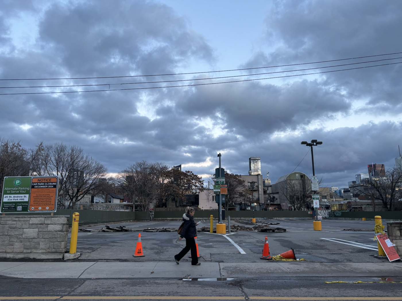 Girl walks by an empty parking lot