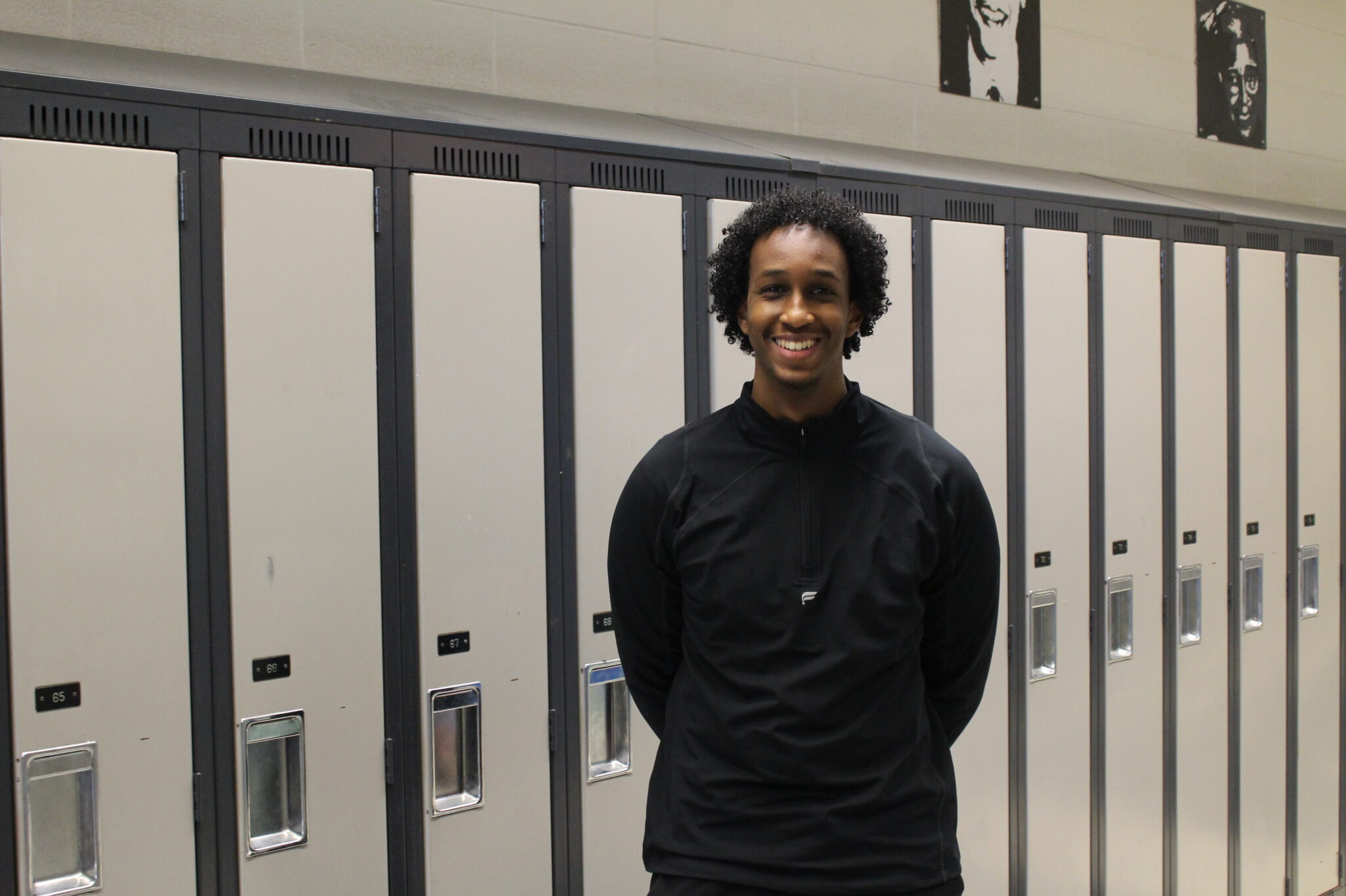 Ismail Mohamud, program facilitator and founding engineer at Coalition of Innovation Leaders Against Racism (CILAR), stands by the lockers inside Kingsview Village Jr. Public School for the program on robots and AI for kids.