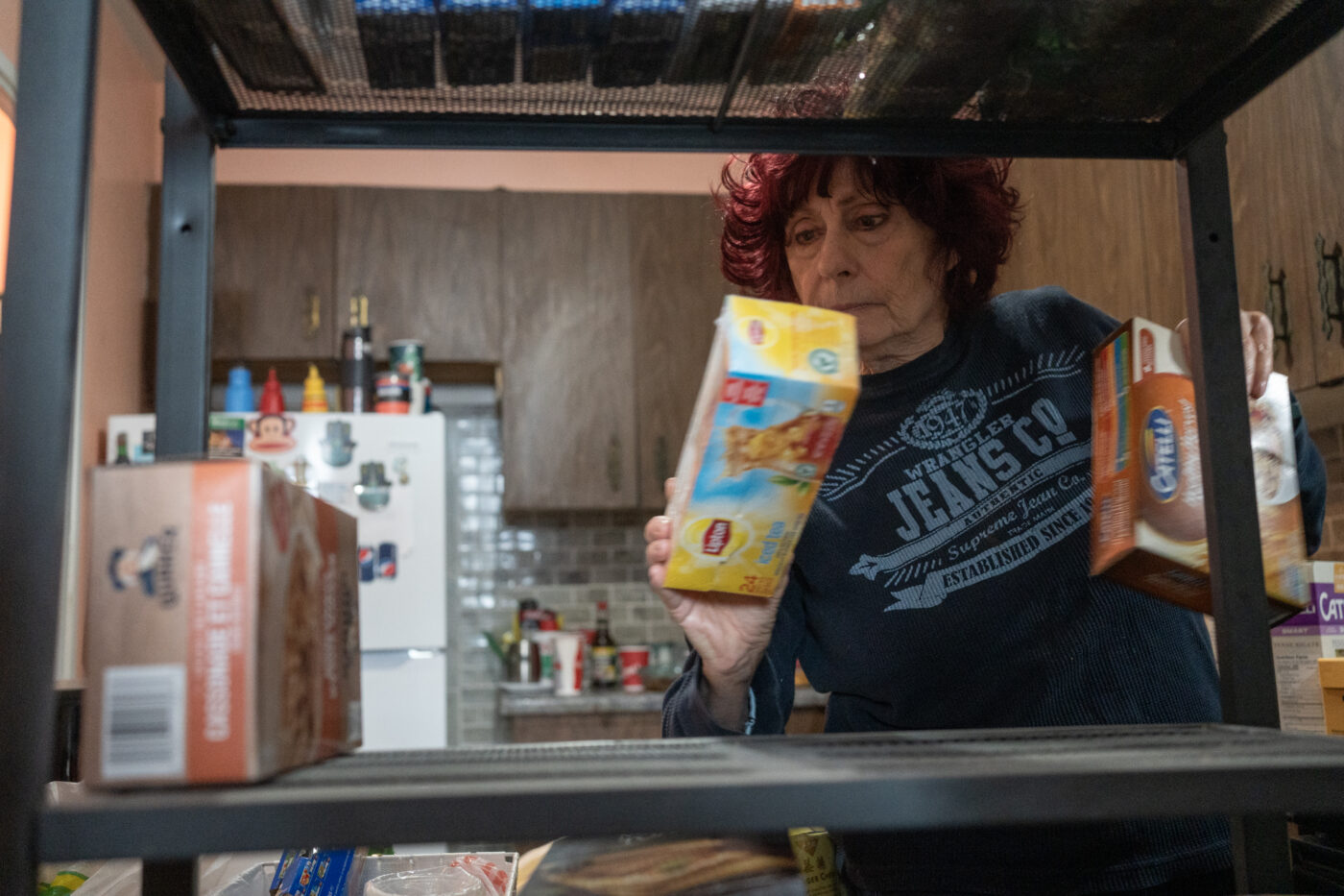 Goldie Wallensky puts away groceries she received from North York Harvest Food Bank in North York, Canada, on January 15, 2025.