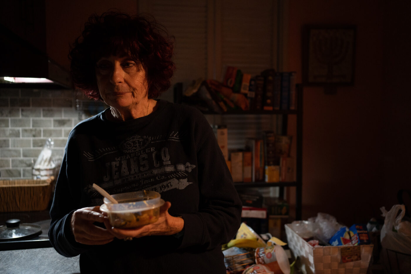 Goldie Wallensky eats dinner which consists of leftovers from a community dinner program earlier in the week in North York, Canada, on January 15, 2025. Goldie a vegitarian says "it can be hard to find food for our diets from food banks or community meal programs."