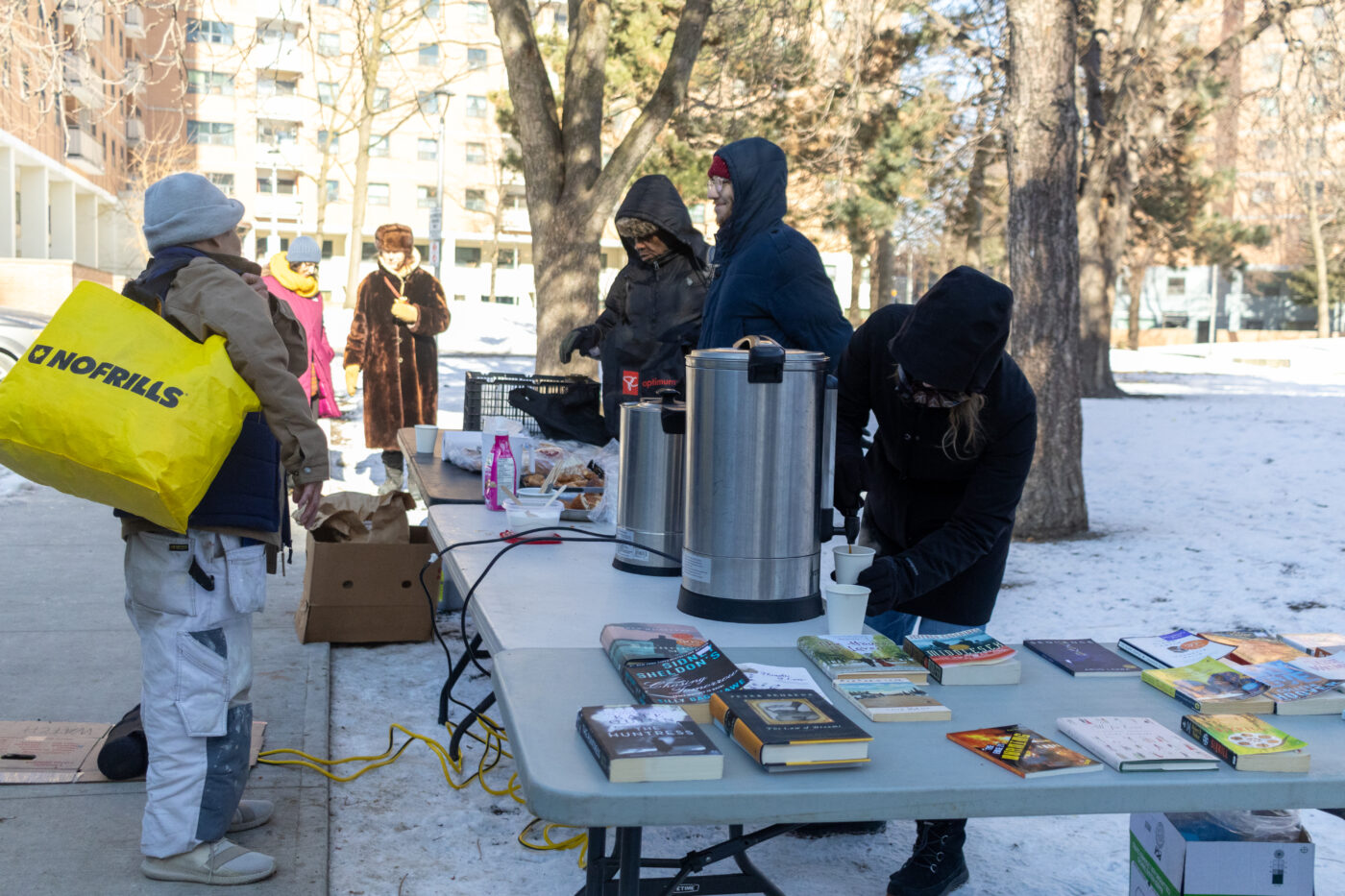 IMG_9979 Volunteers set up a resource tables featuring everything from harm reduction supplies and housing resources to sexual health education pamphlets, as well as a BookShare table where anyone can grab a book to take home.
The last stop is usually Coffee & Conversations, a program that encourages residents to grab a coffee, tea or hot chocolate as well as some pastries and sandwiches for free. The coffee-shop like operation helps anyone who's hungry access food immediately — and it creates a friendly space where neighbours can hang out and chat. Amartya Smaran/The Green Line.