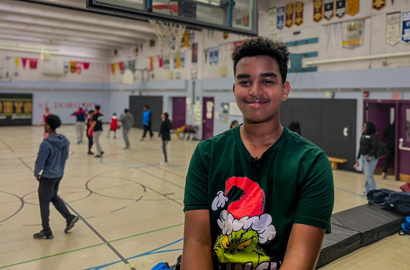 Abel Tesfaye, student in STEM Athletics program sits in the gym of St. Dorothy Catholic School.