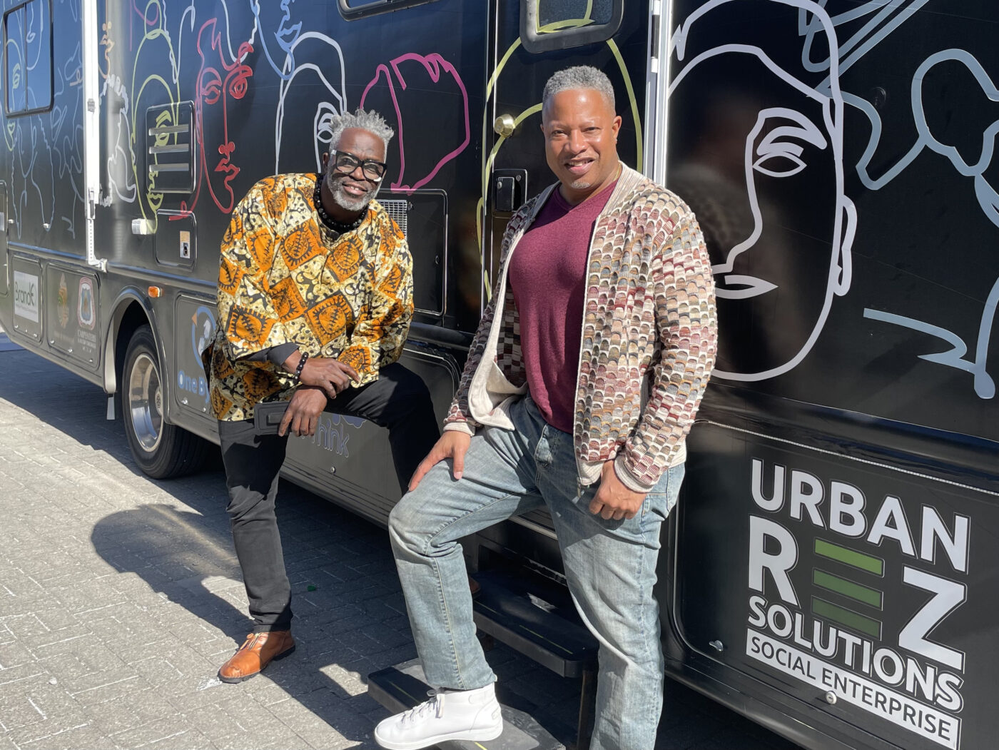Farley Flex and Roderick Brereton Farley Flex and Roderick Brereton standing by community mobile unit that curbs youth crime.