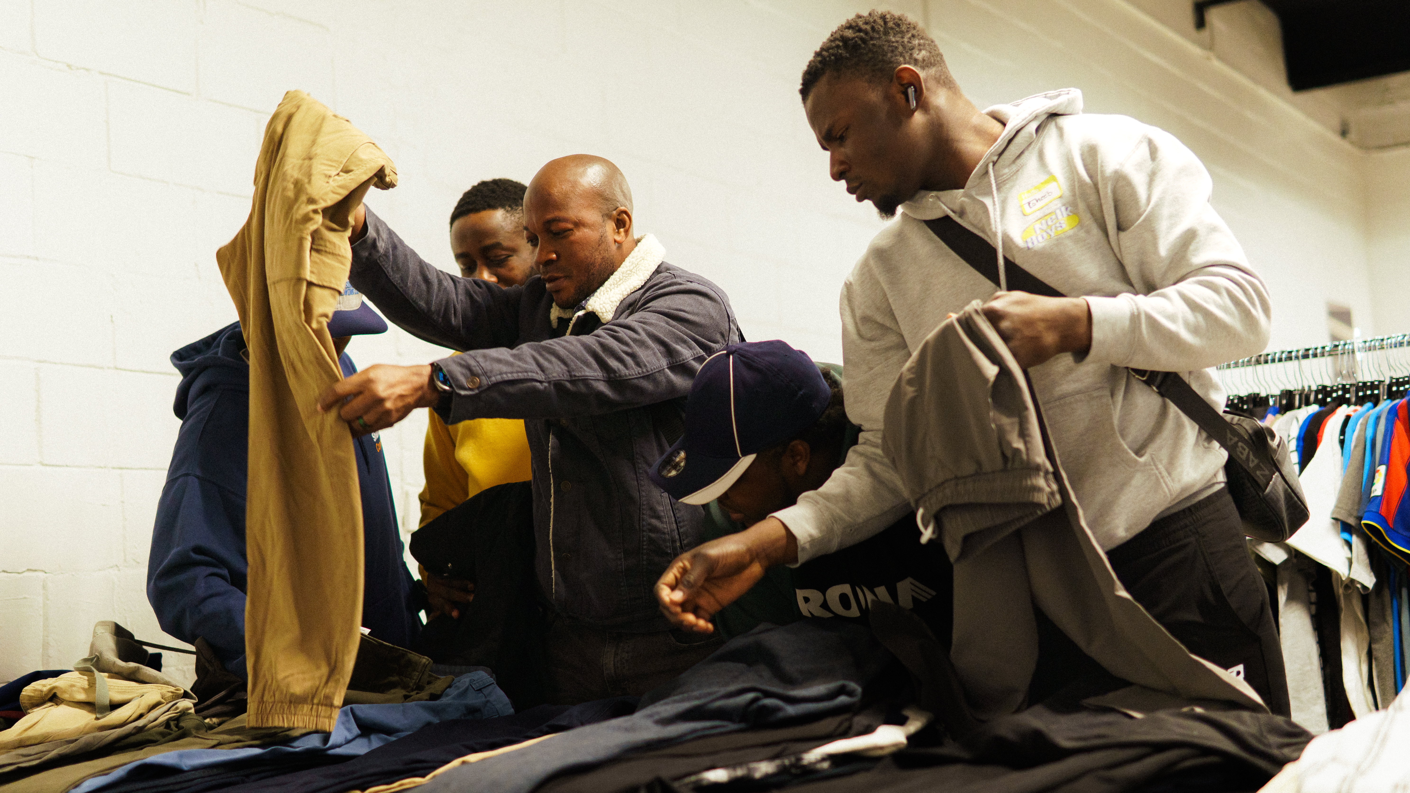 Attendees at Toast and Threads Attendees look for pants at Toast and Threads event that builds community for the unhoused.