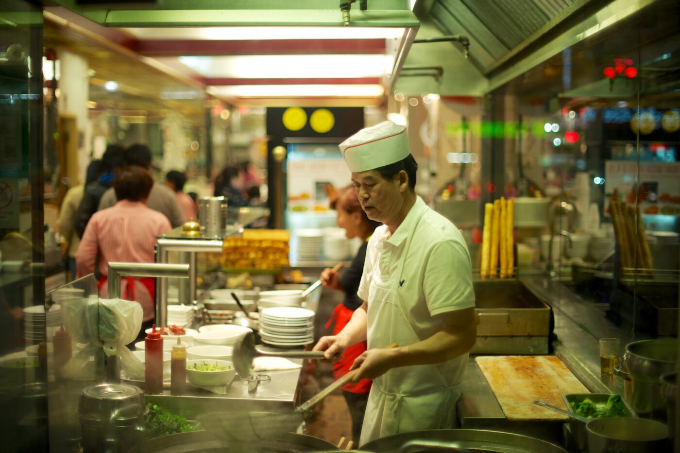 Chinatown restaurant A chef is seen cooking through a restaurant window on Spadina Avenue near Dundas Street West. Philip Johnson/Flickr.