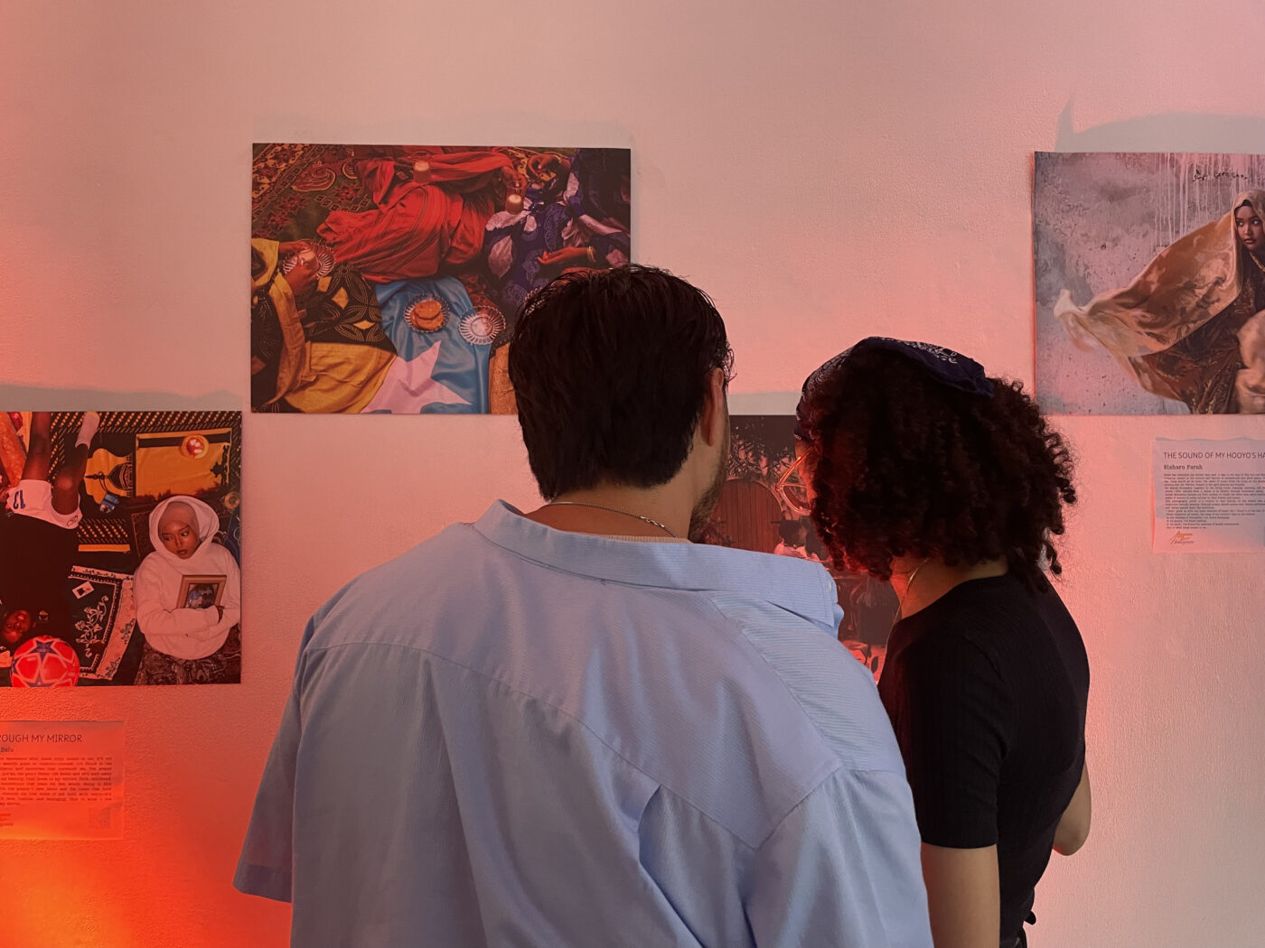 4TWE Exhibition People look at photographs taken by youth artists in the West End.