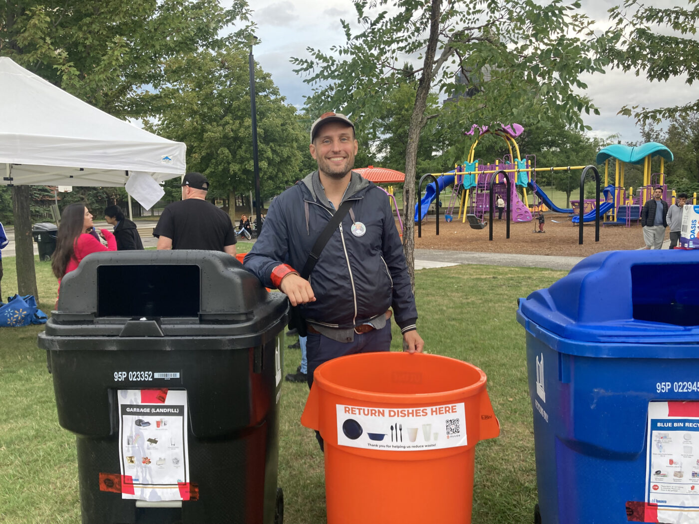 Quentin De Becker works to reduce waste by bringing reusable utensils to a farmers market.