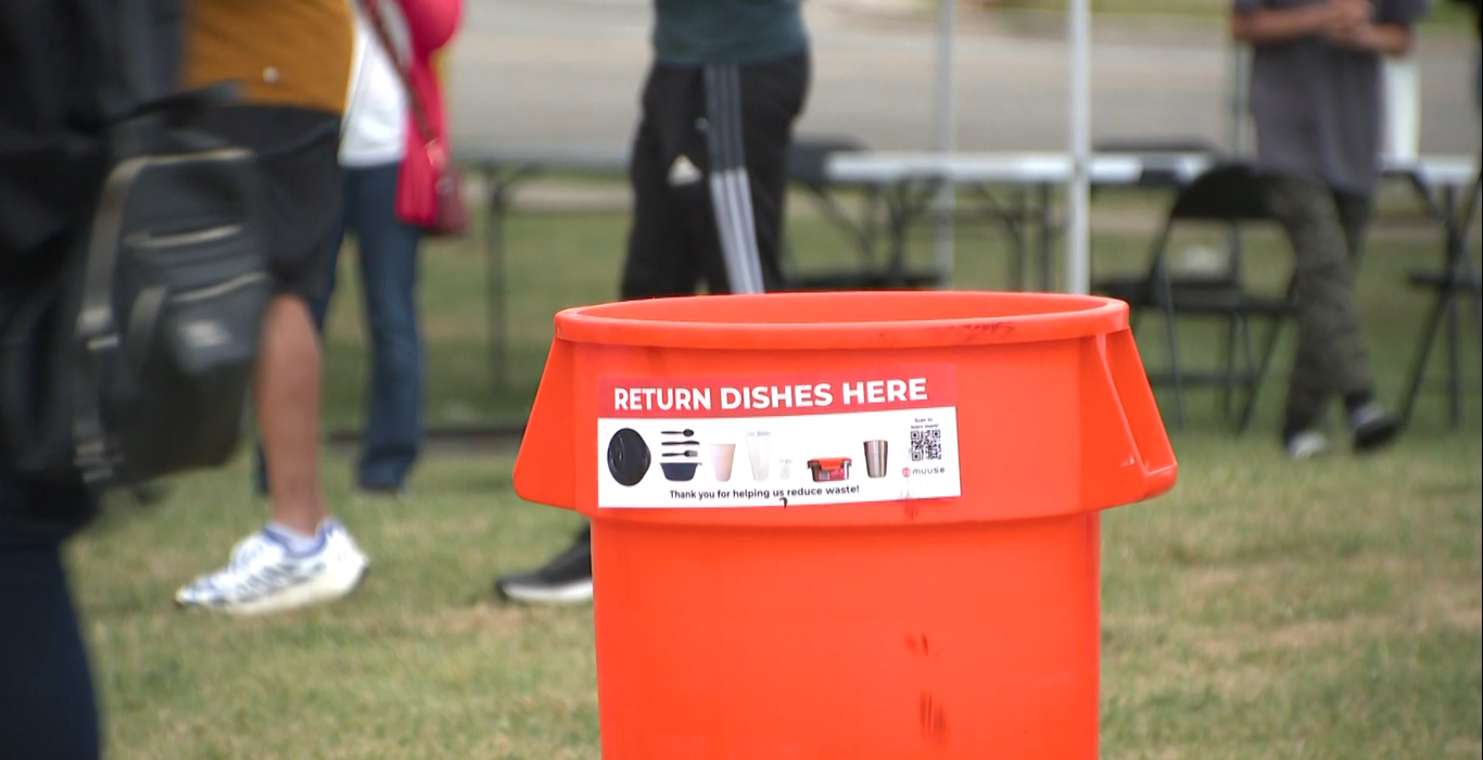 Orange bin for reusable utensils helps reduce waste at Scarborough Farmer' Market.