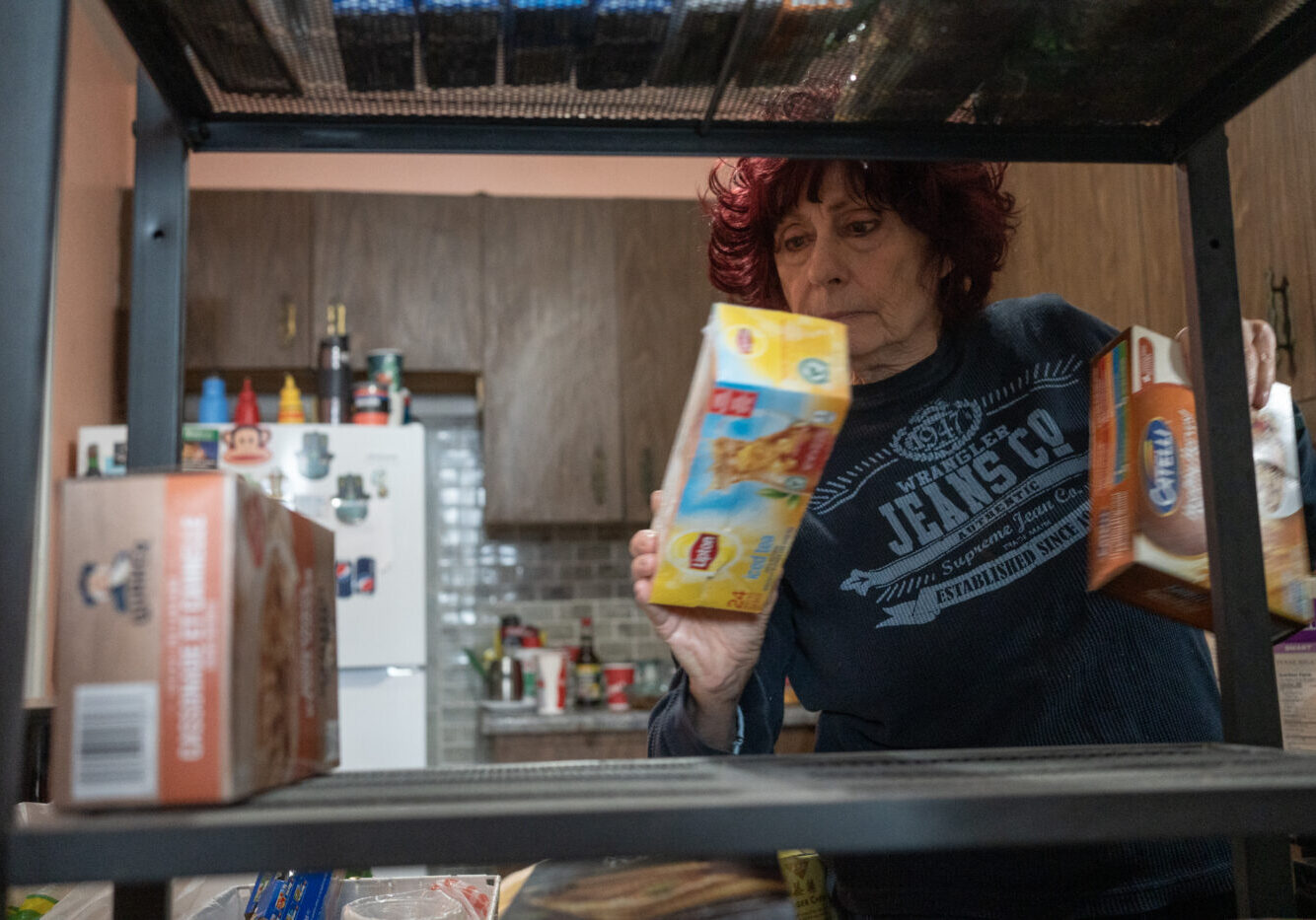 Goldie Wallensky puts away grocies she recieved from North York Harvest Food Bank in North York, Canada, on January 15, 2025. Goldie a vegitarian says "it can be hard to find food for our diets from food banks or community meal programs."