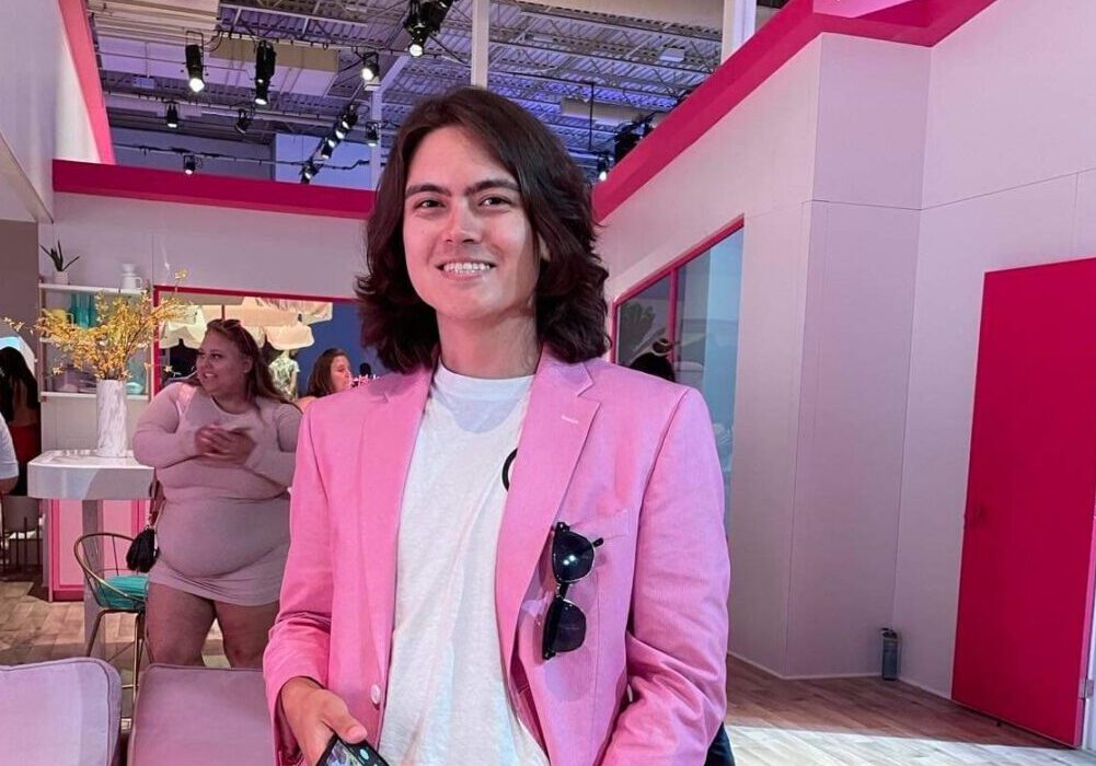 A young man in a pink blazer