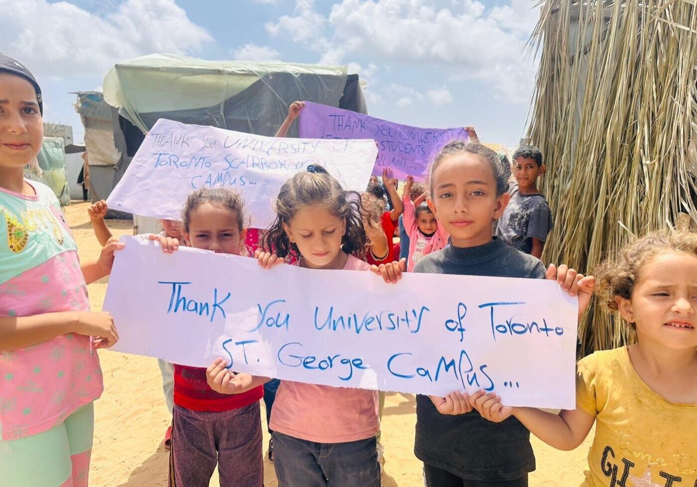 Young Palestinian children holding up a banner that reads “Thank you University of Toronto St. George campus.”