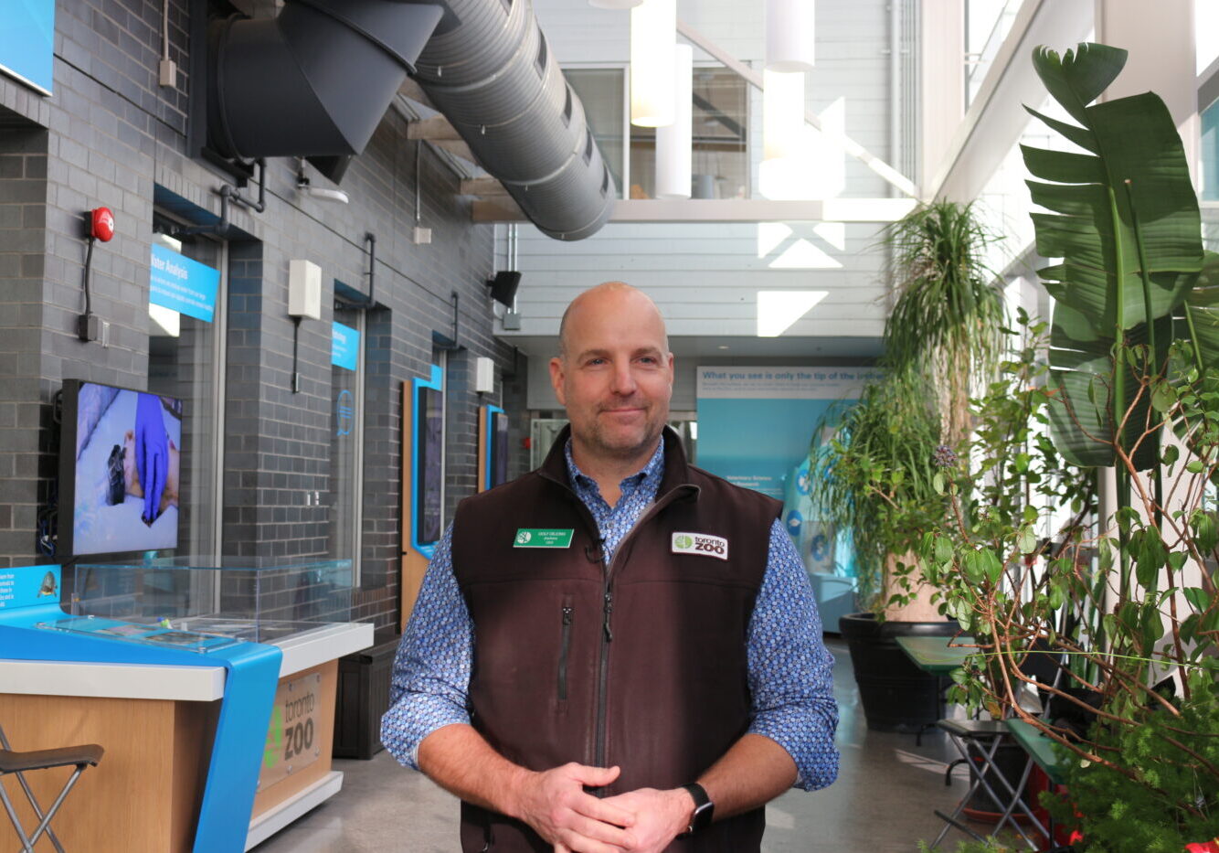 Toronto Zoo CEO Dolf Dejong stands in front of the surgical suites and beside plants.