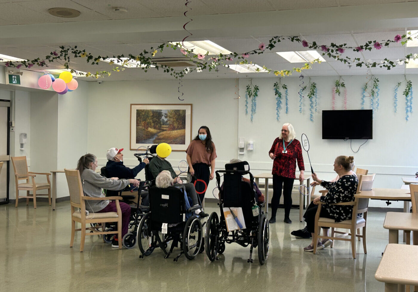 Residents at Main Street Terrace Long-Term Care Home play games together in their main room.