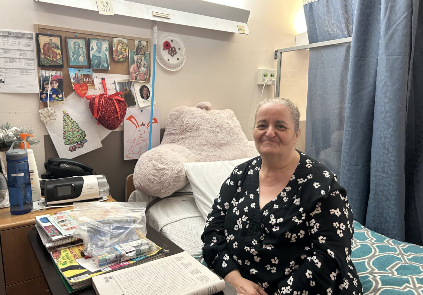 Dina Kotsovolos, a resident at Main Street Terrace Long-Term Care Home, sits on her bed.