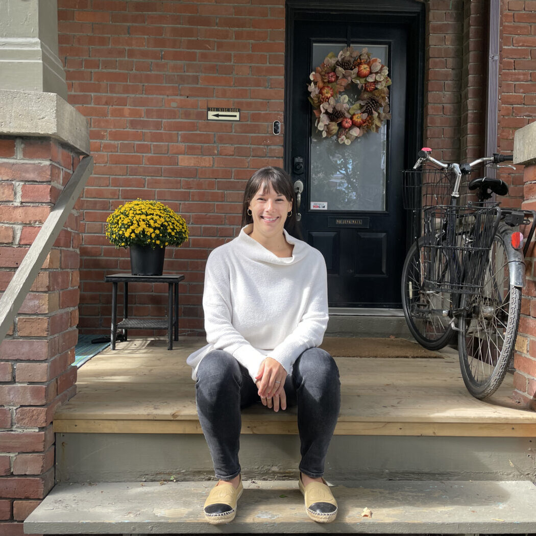 Jackie Da Silva sits in front of the co-ownership house in Bloordale Village.