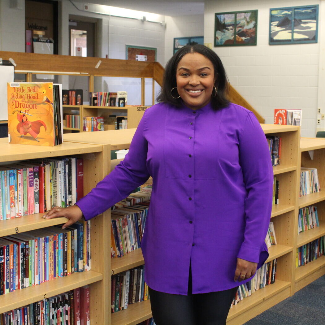 Camesha Cox, founder of The Reading Partnership stands by library.