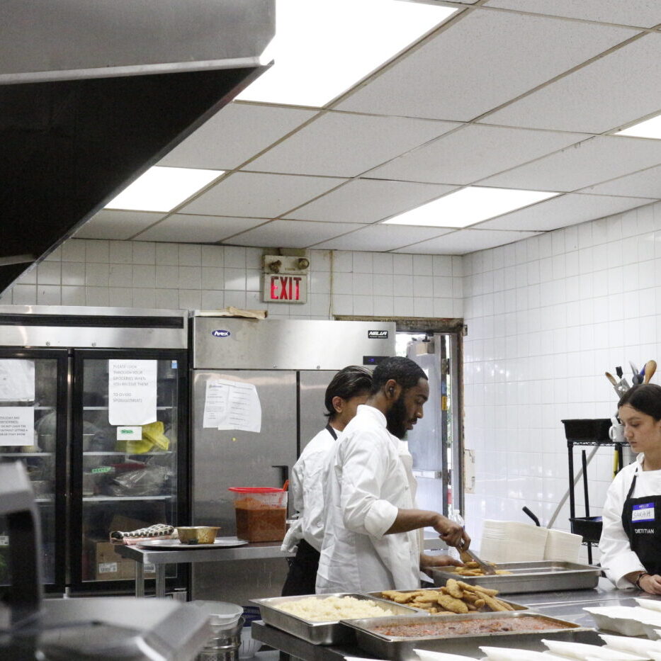 Youth prepare meals inside Frontlines kitchen.