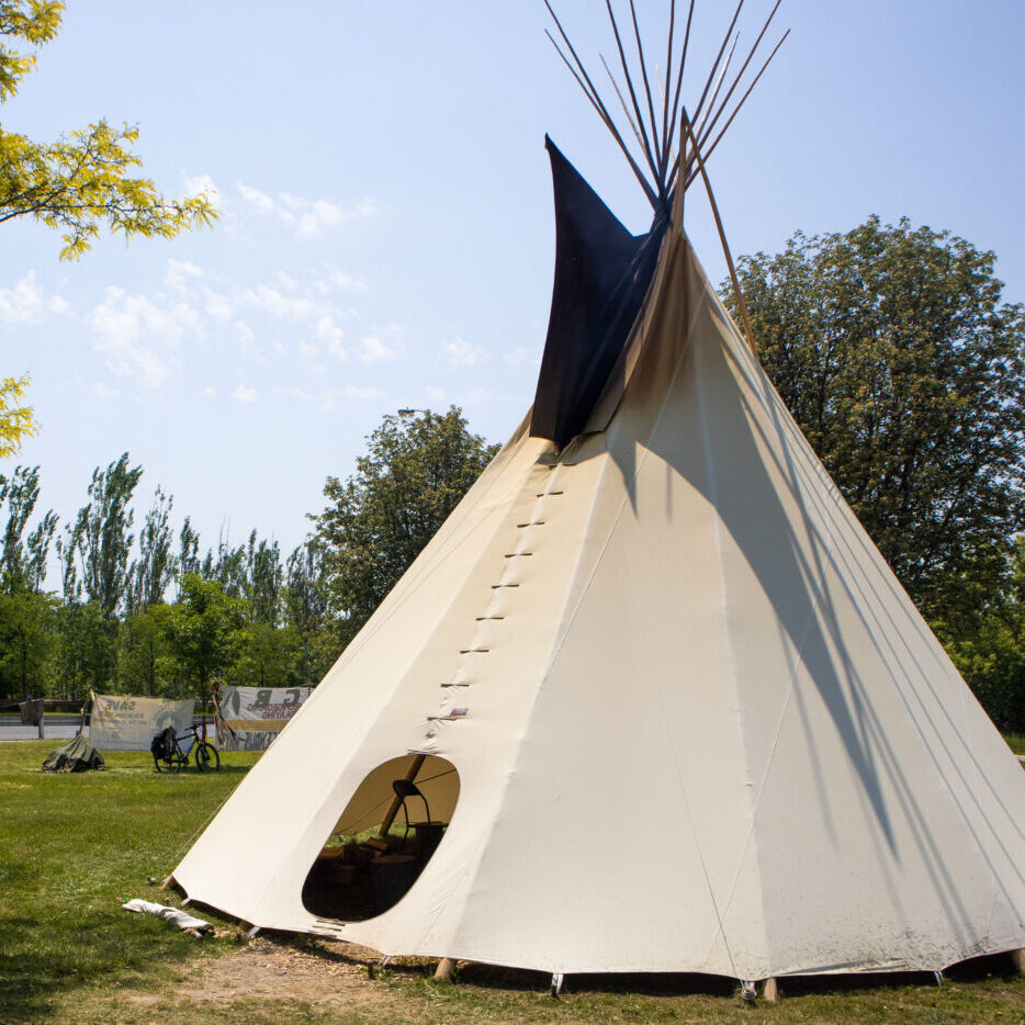 A tipi in a park.