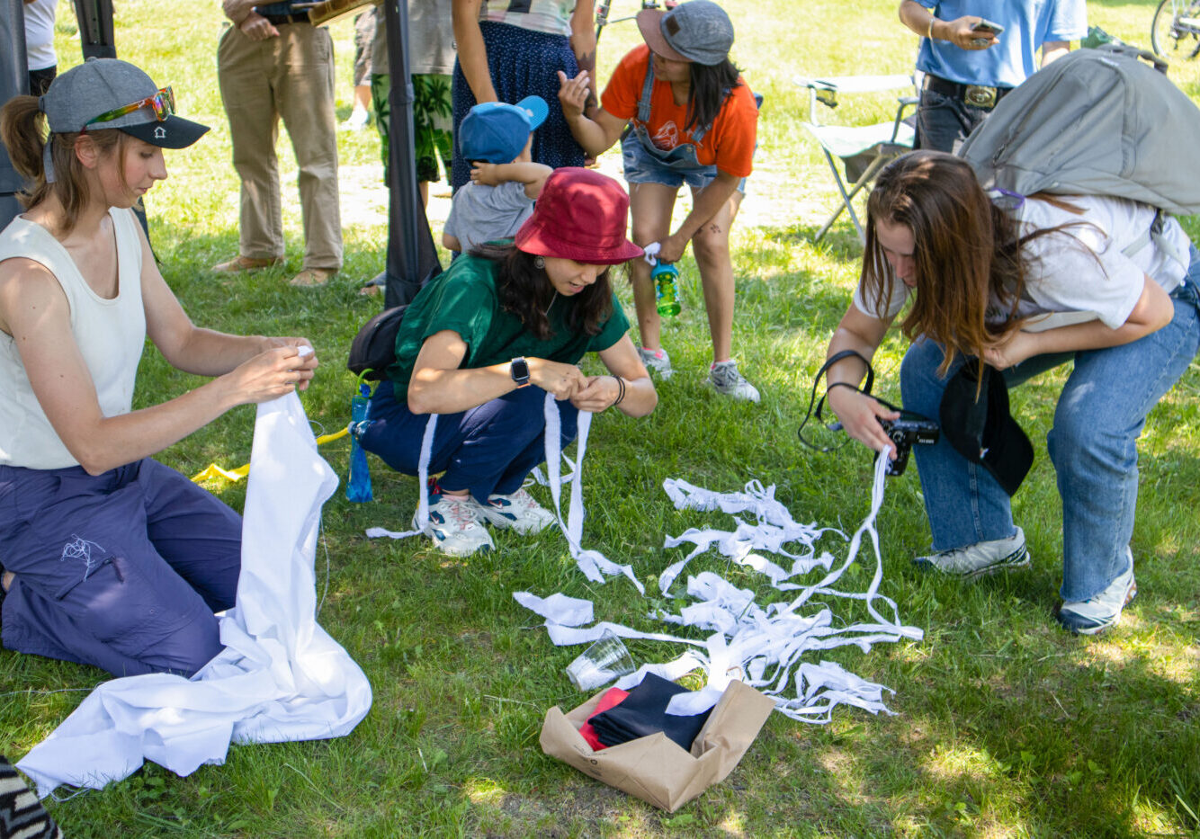 A group of volunteers tear ribbon.
