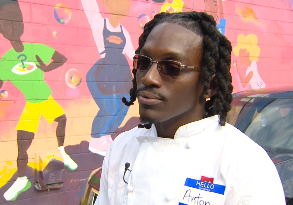 Anton Lewis, graduate and chef at Frontlines, stands outside the Frontlines building.